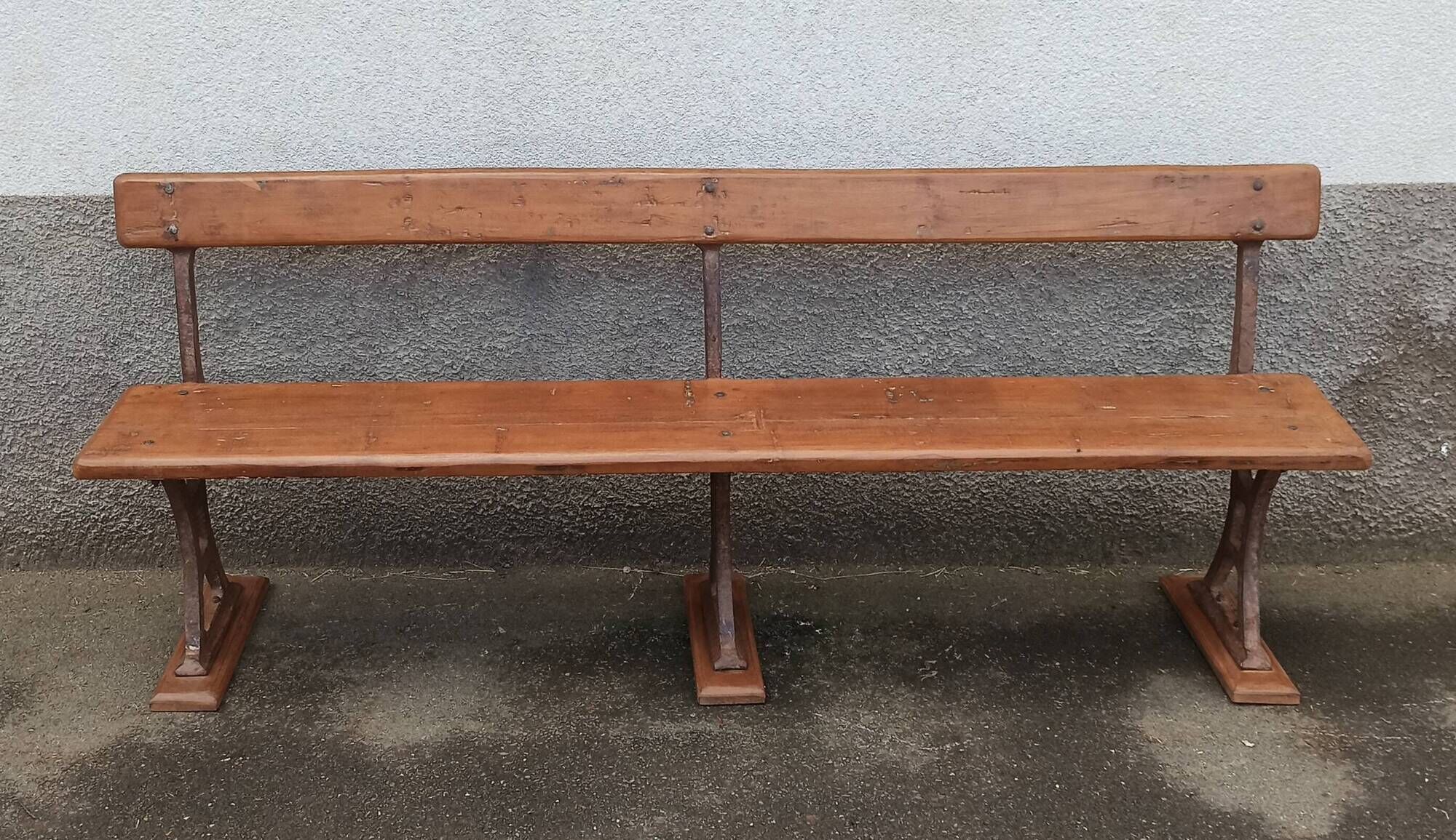 Old wooden bench with cast iron base
