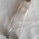 Antique silver-plated sugar tongs with lion's paws.