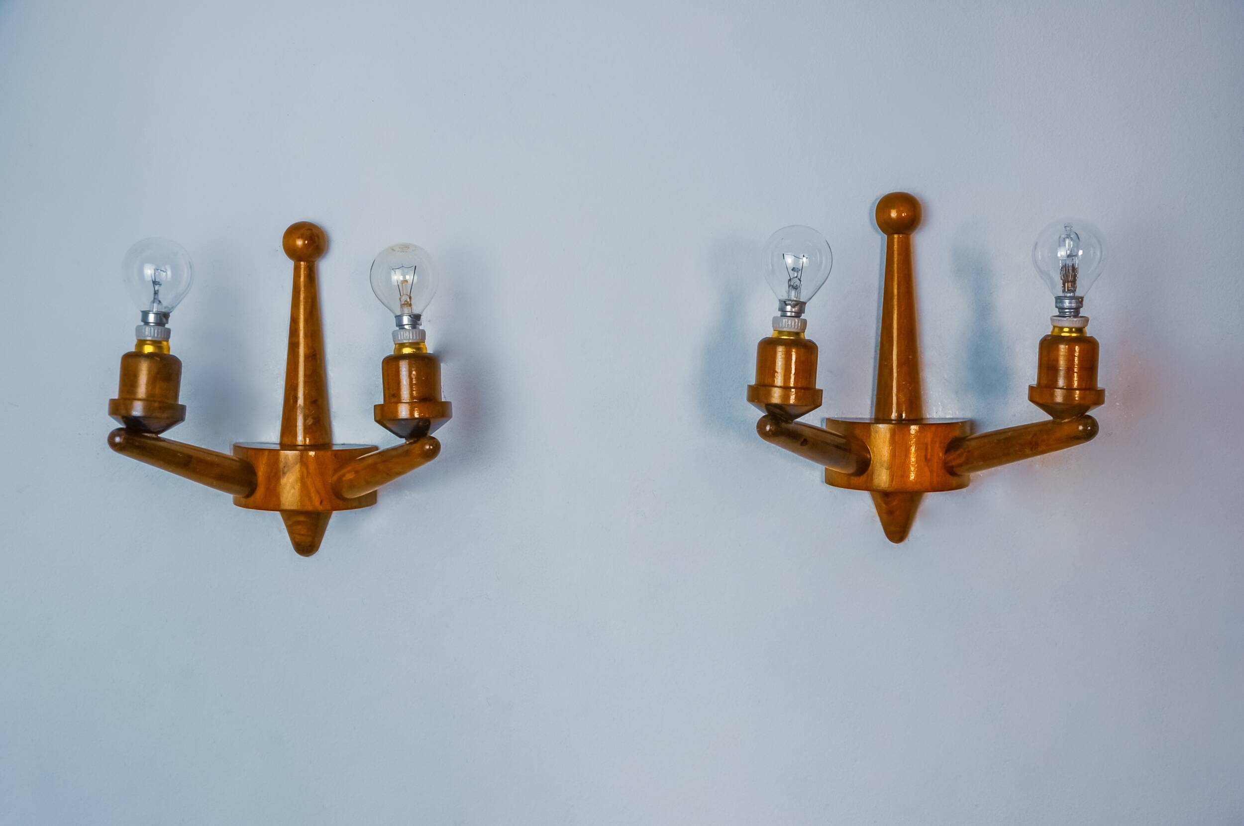 Pair of two-armed art deco "ball" wall lights, carved wood, France, 1960