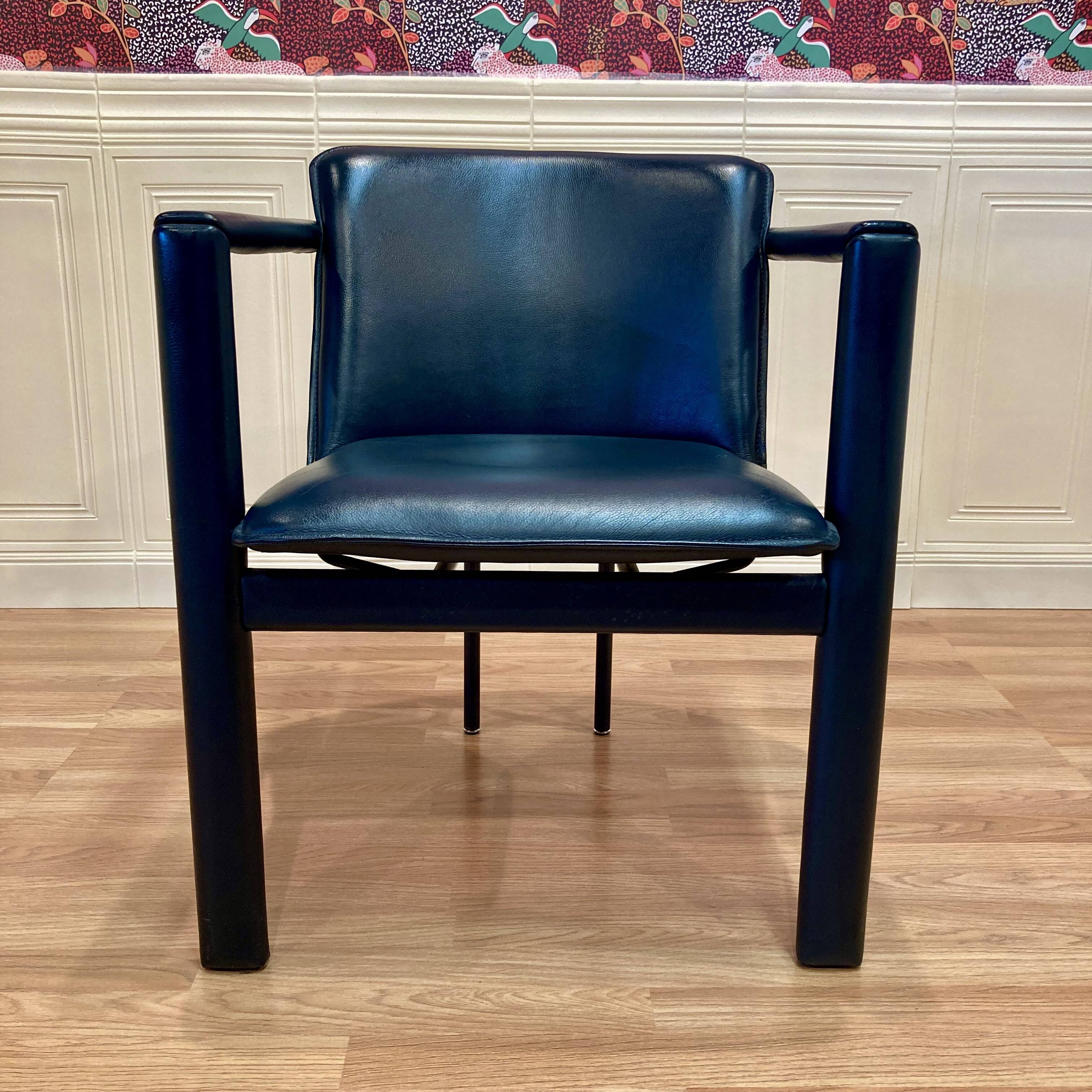 Set of 3 designer leather and metal armchairs.