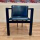 Set of 3 designer leather and metal armchairs.