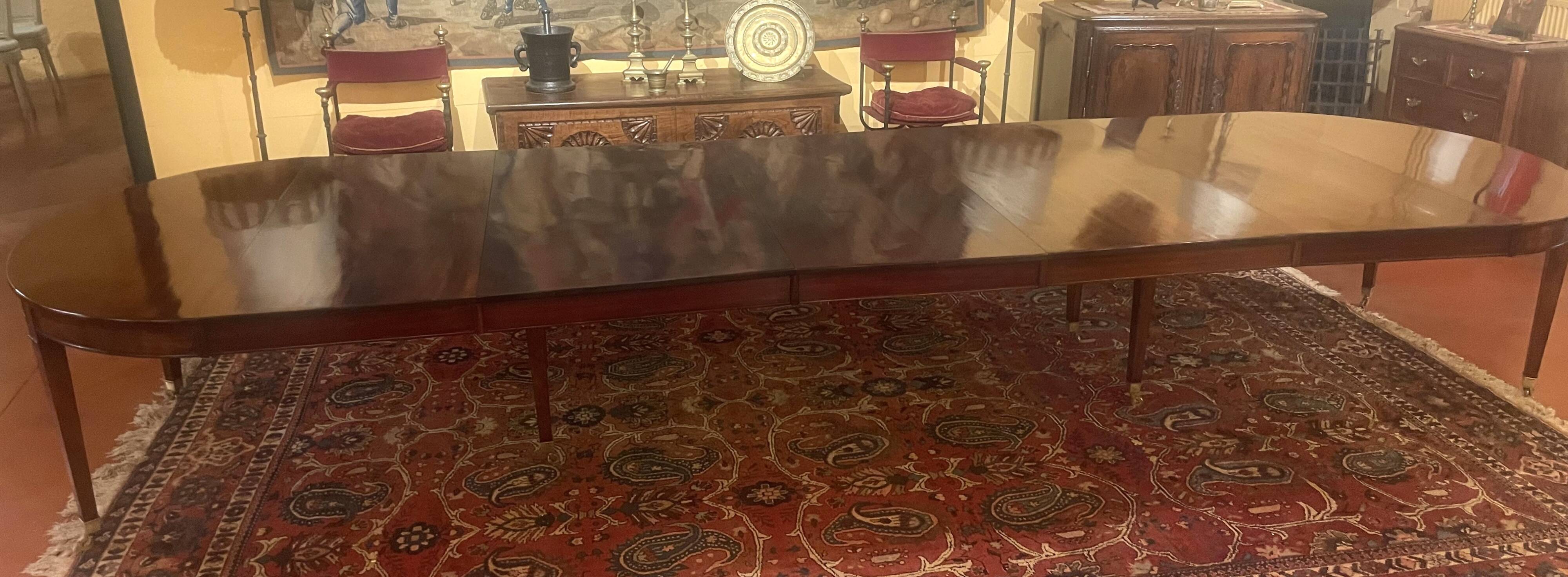 Extensible dining table from the Louis XVI period in mahogany with a banded top.