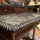 Antique English mahogany dressing table with carved details, black marble, and mirror.