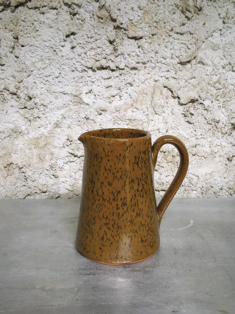 Milk pitcher in spotted sandstone