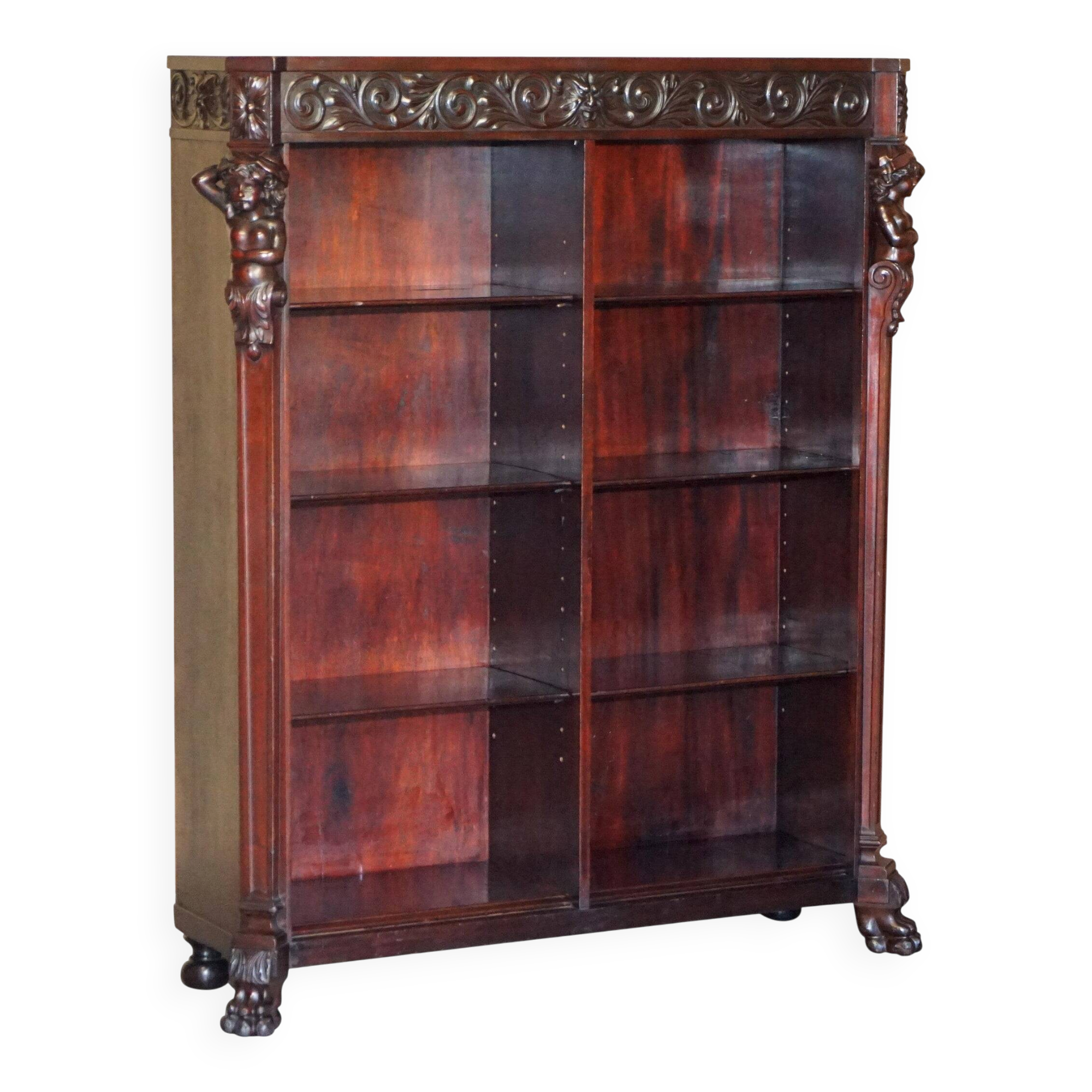 Hand-carved library circa 1900 in hardwood with Hermes statues.