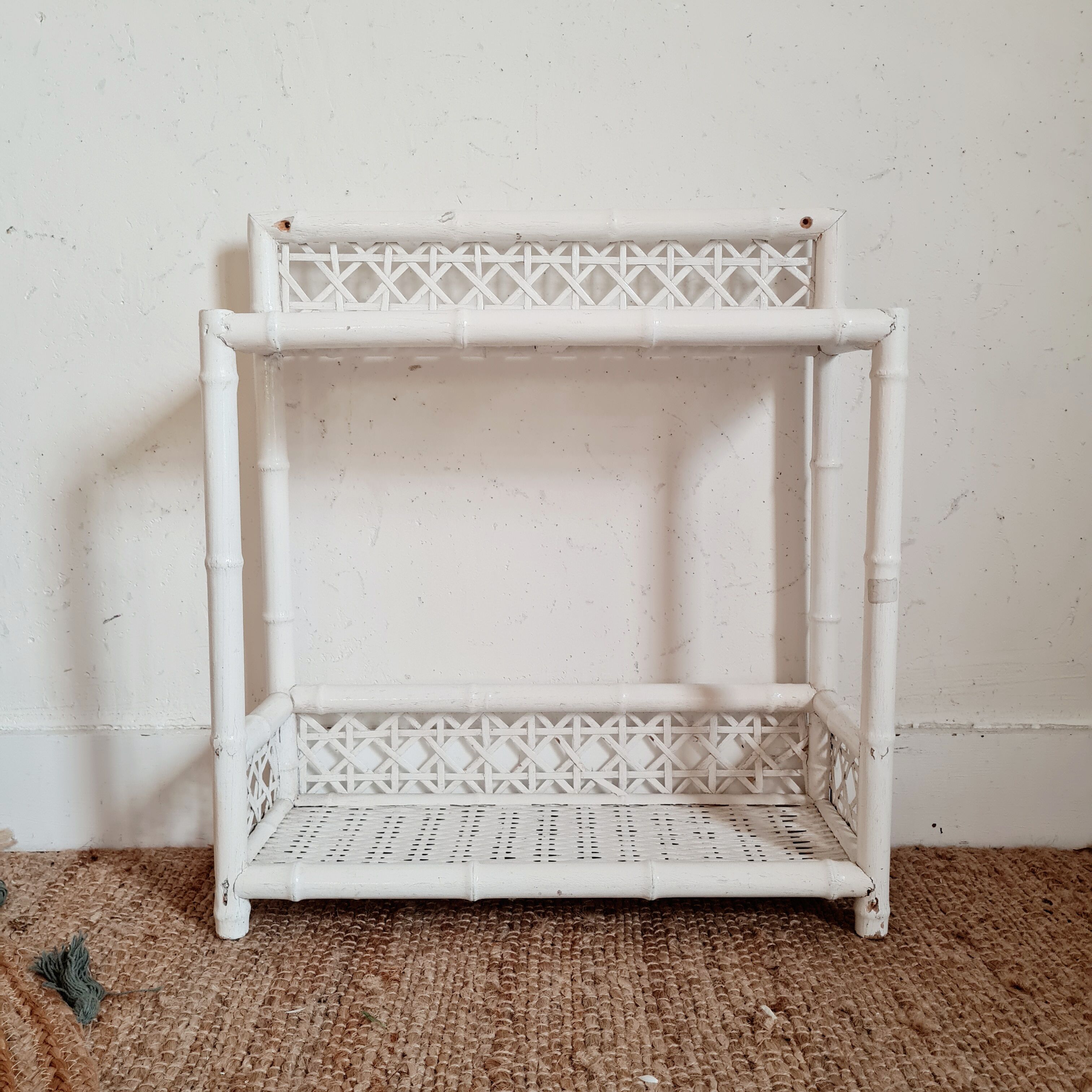 Vintage rattan and bamboo shelves painted white