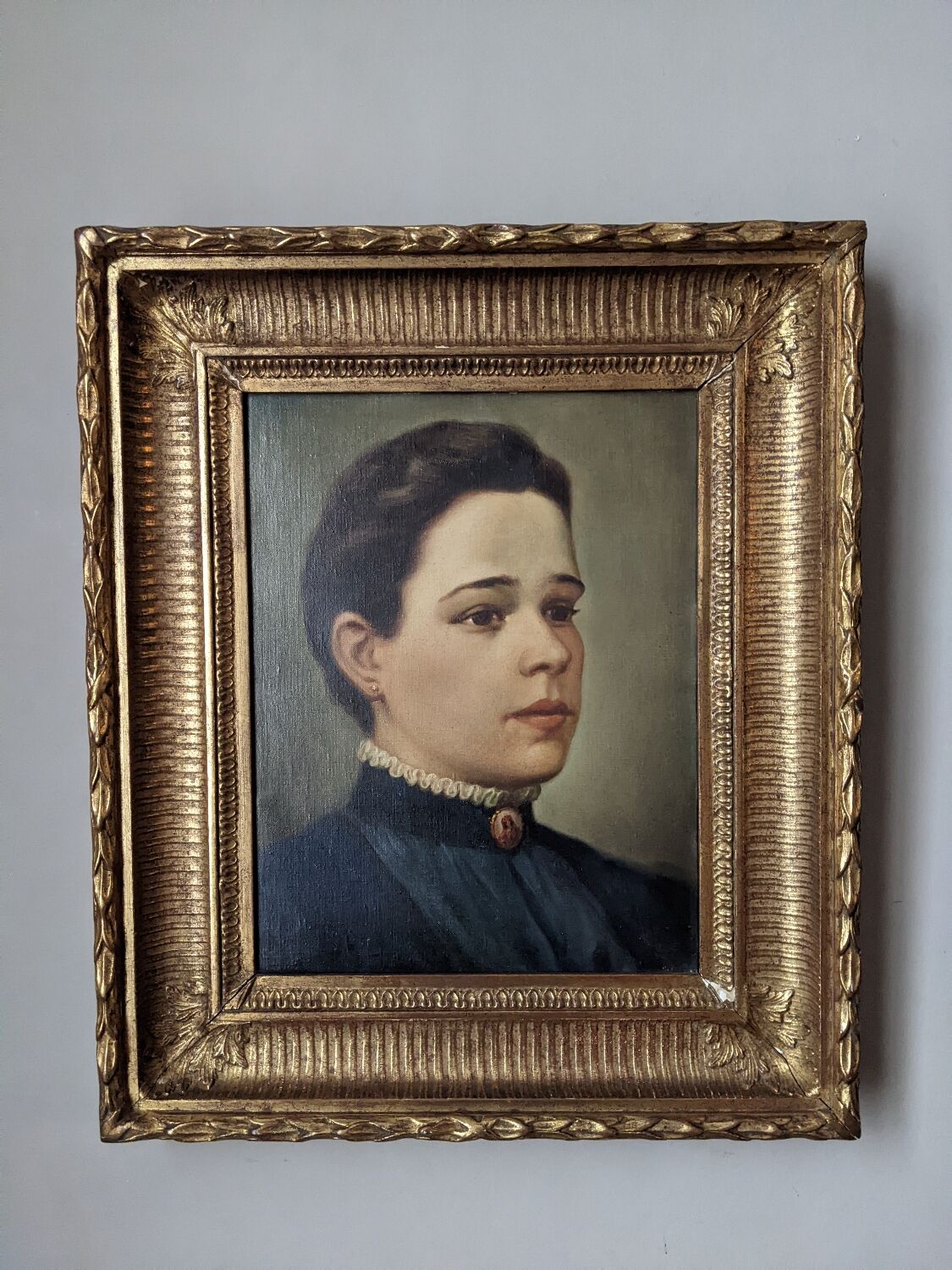 Oil on canvas portrait in an antique gilded wooden frame.