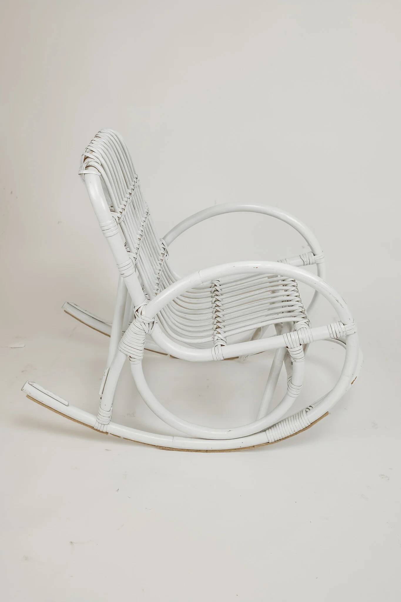 Vintage rocking chair for children in rattan/bamboo.