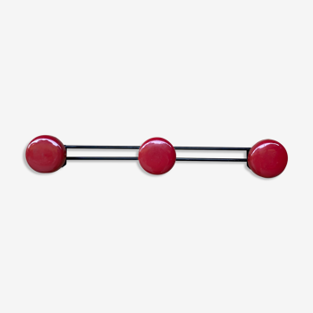 Wall coat holder in vintage red metal.