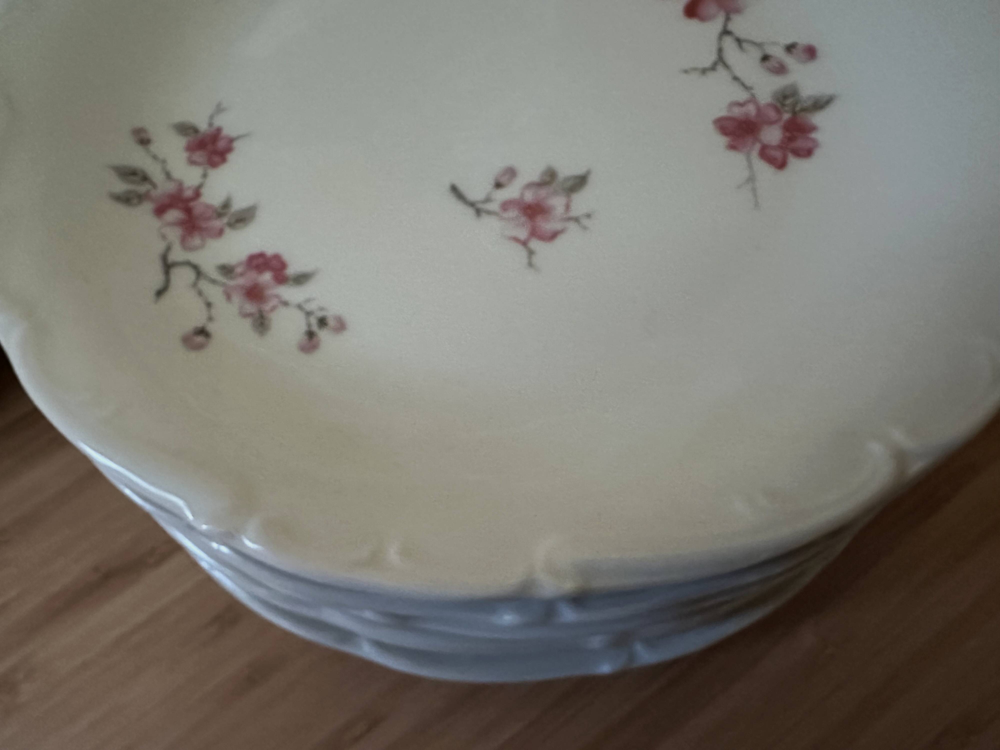 12 plates and 1 serving dish, white porcelain with apple blossom patterns.