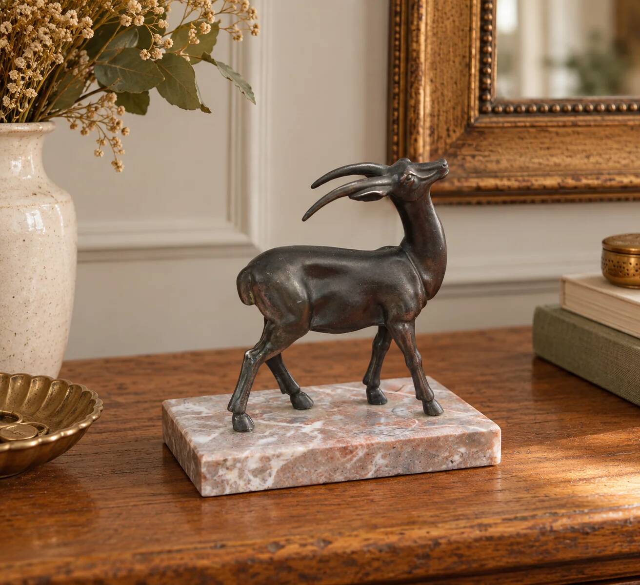 Vintage antelope gazelle bookend in patinated metal on a marble base.