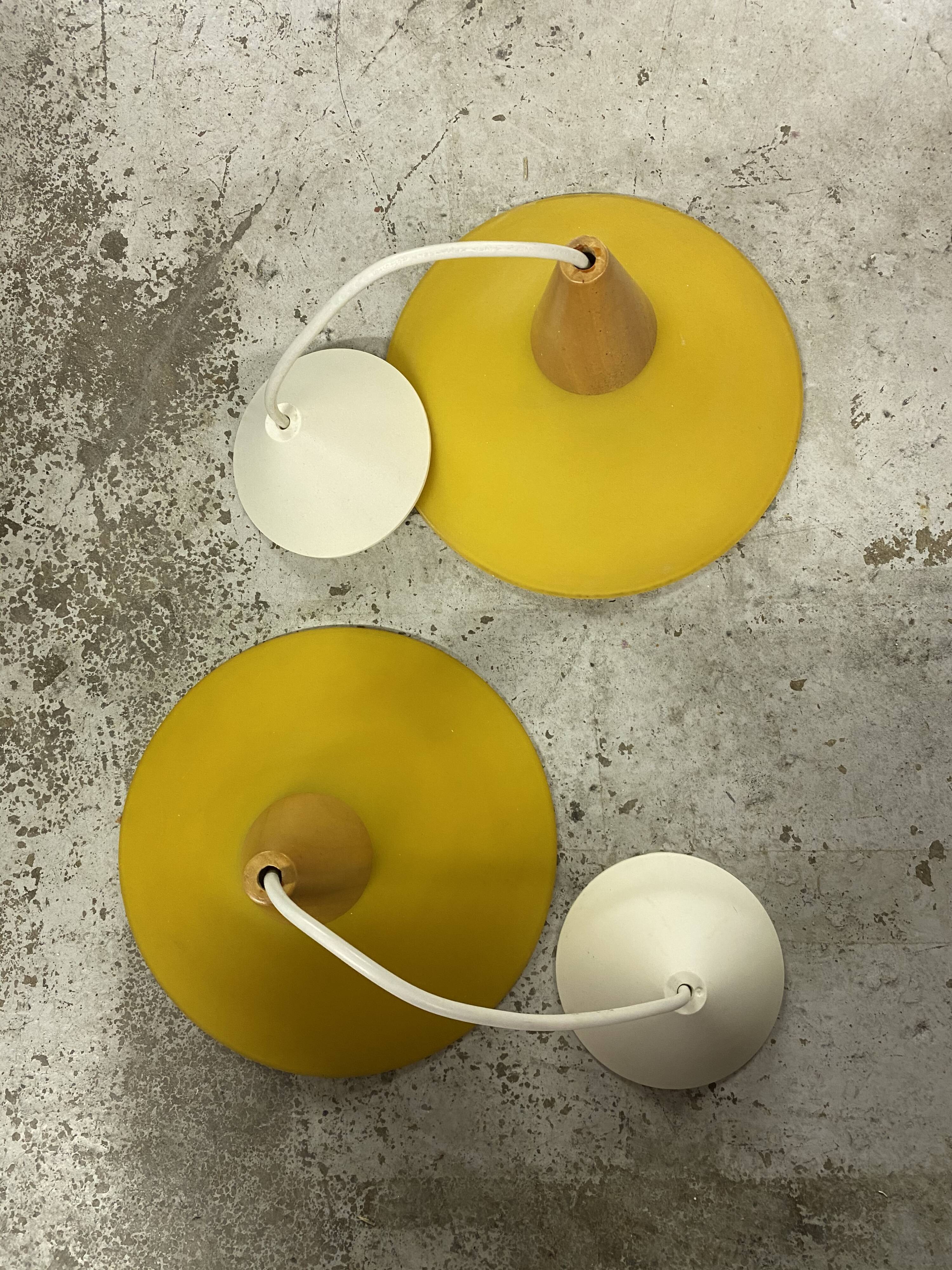 Duo of yellow glass pendant lamps