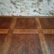 Antique French walnut table with six drawers, parquet top, early 20th century.