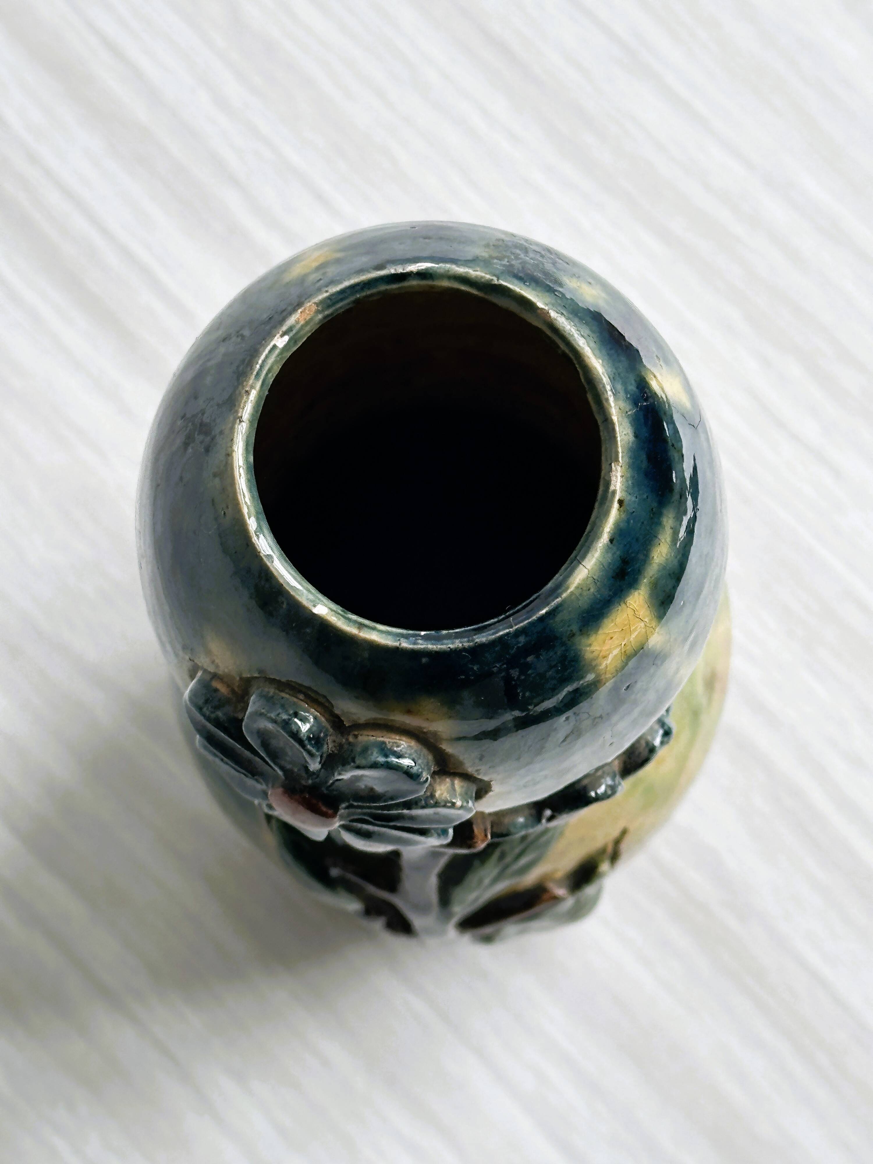 Very colorful glazed earthenware vase, old vase with floral decoration.