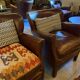Brown cowhide armchair with a reversible seat cushion in KELIM.