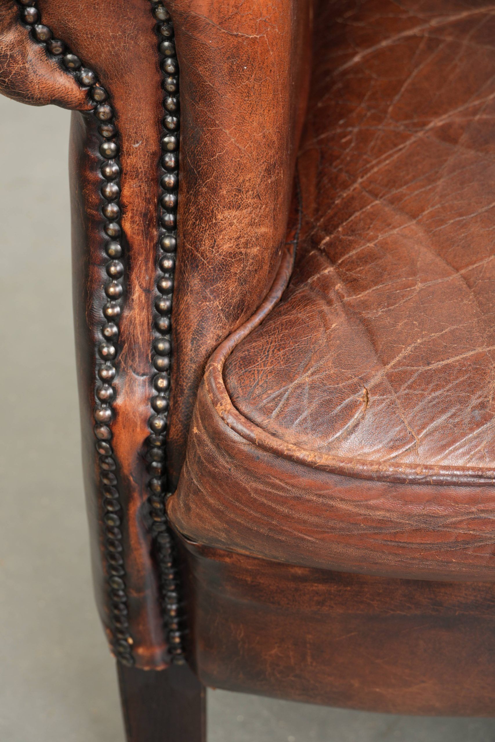 Vintage sheepskin wingback armchair in a deep brown colour finished