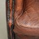 Vintage sheepskin wingback armchair in a deep brown colour finished