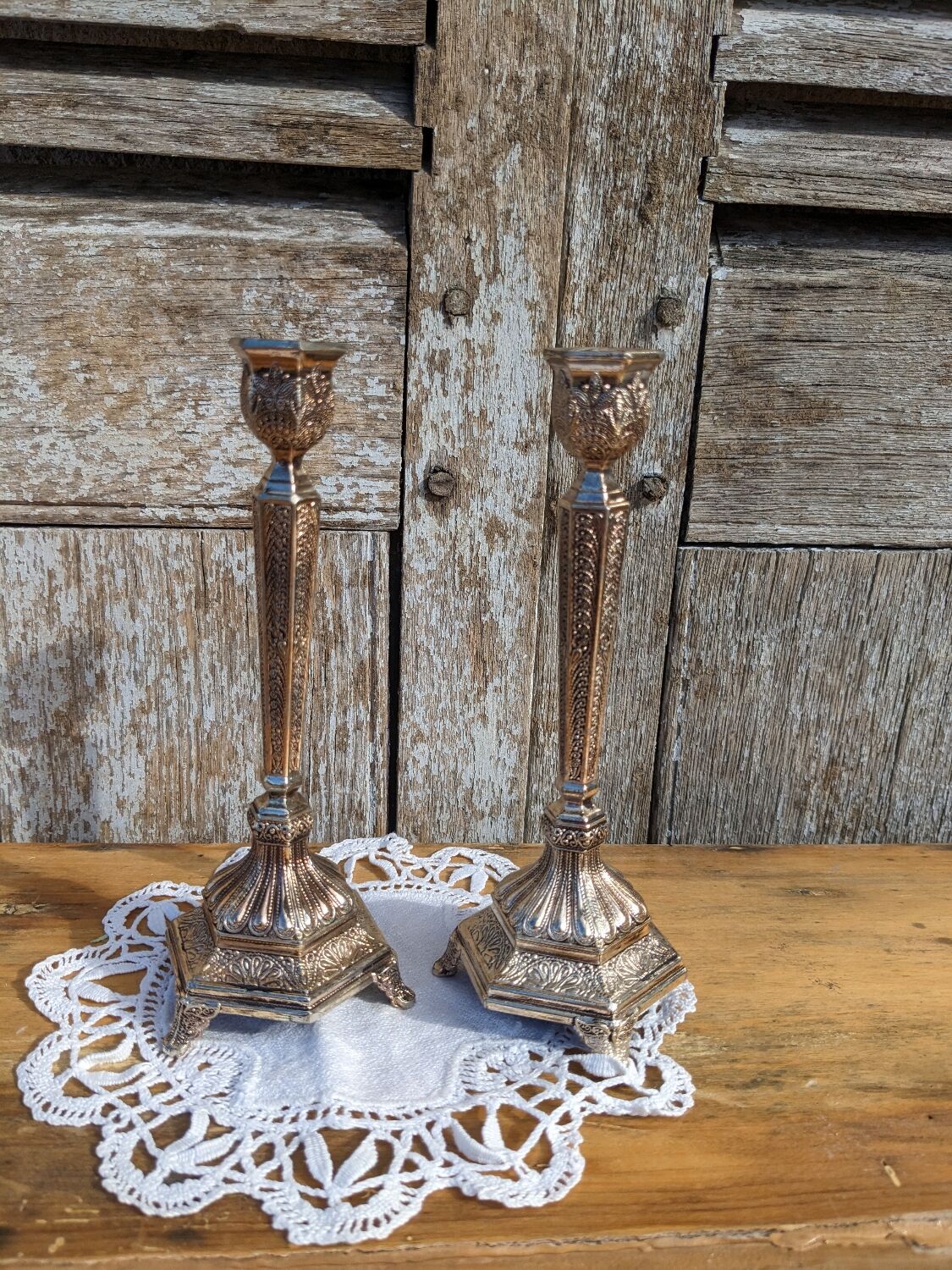 Pair of chiseled metal candle holders