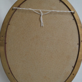 Oval mirror in gilded wood