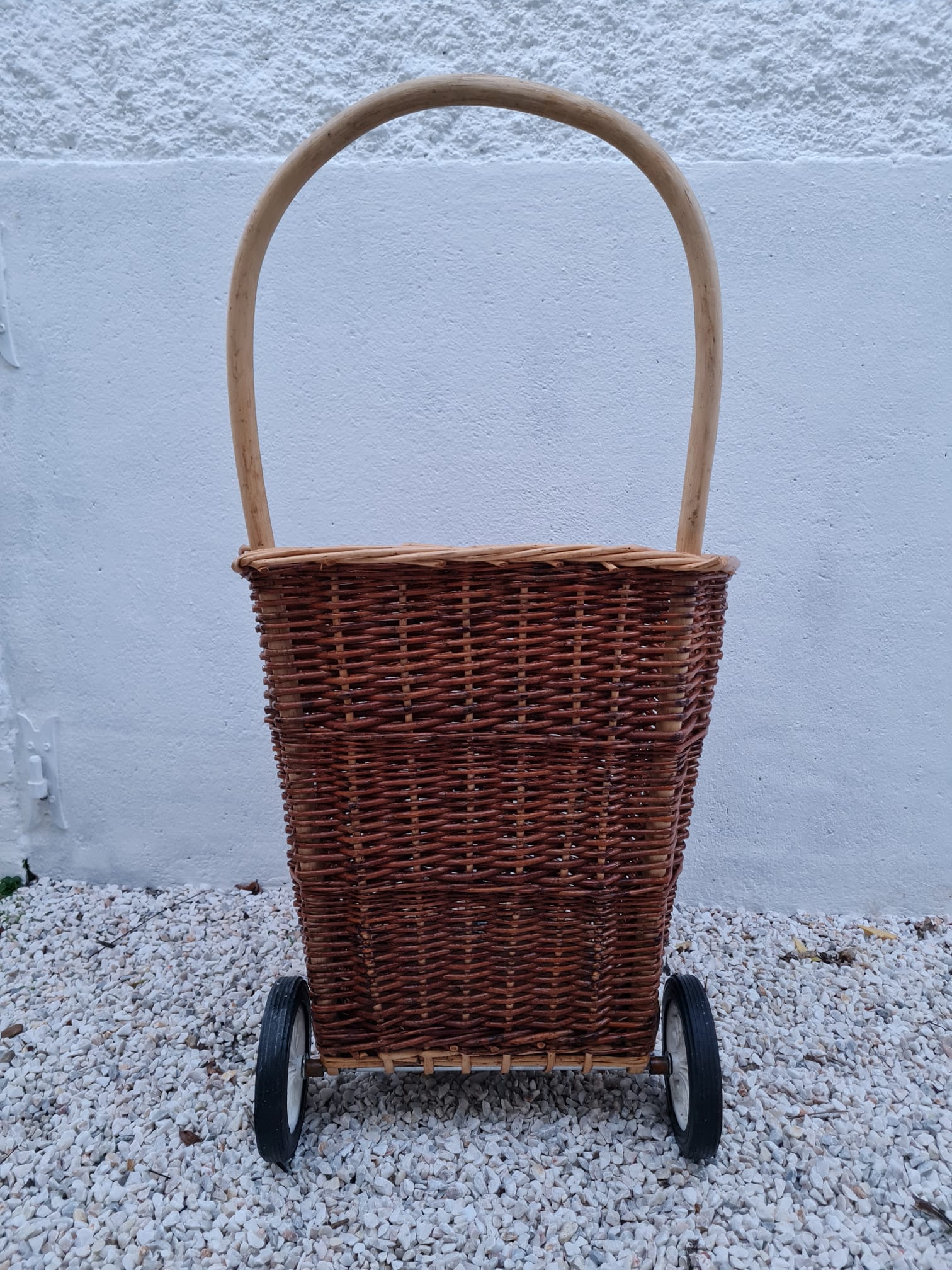 Vintage wicker log basket on vintage wheels