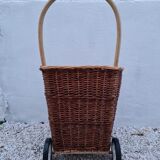 Vintage wicker log basket on vintage wheels