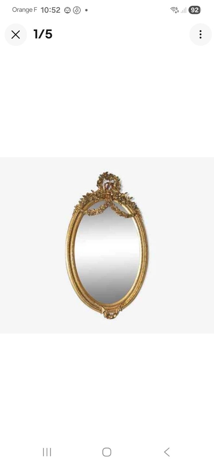 Oval mirror in Louis XVI style in wood and gilded stucco.