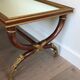 Coffee table in patinated and gilded carved wood with mirror top