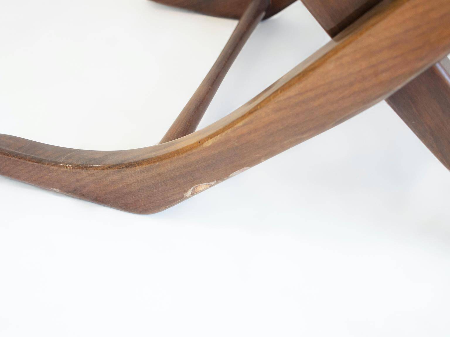 Pair of varnished wooden reclining armchairs, upholstered in lightweight fabric.