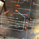 Black metal server and earthenware tiles with geometric patterns