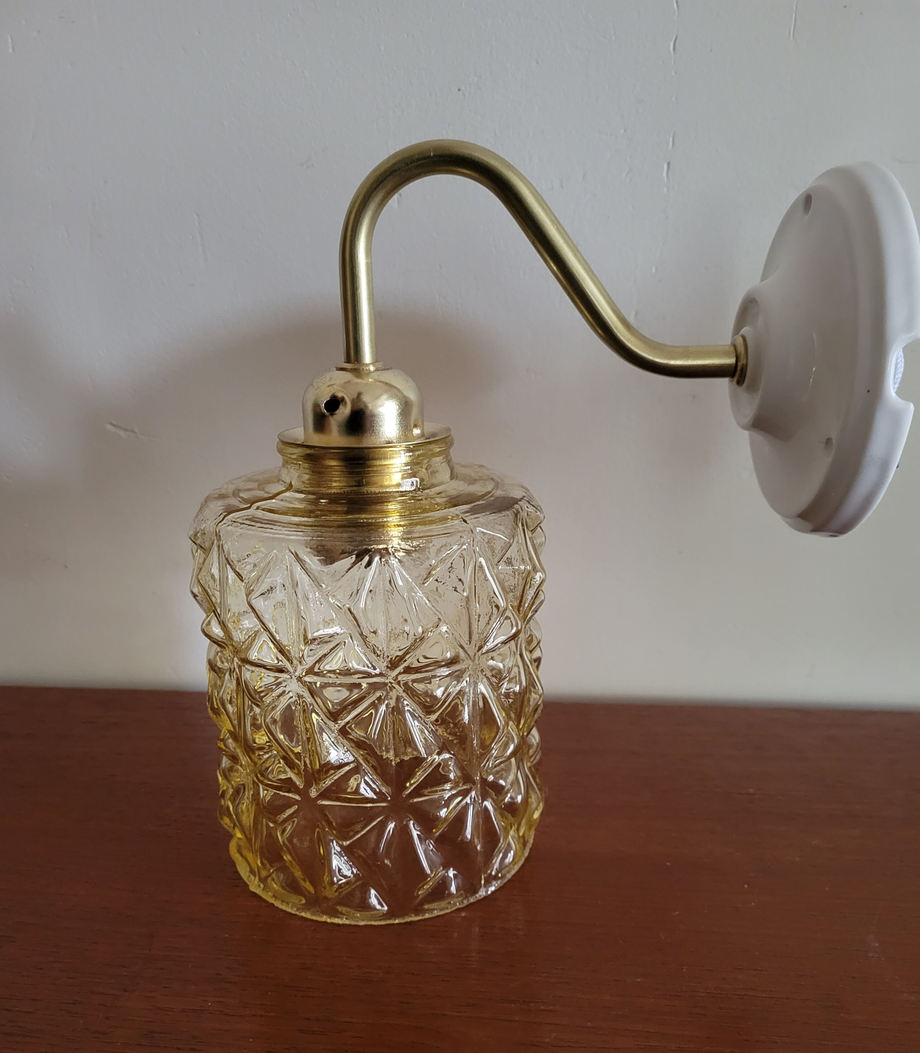 Brass wall lamp and molded glass