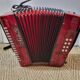 Red Aidi R accordion in his suitcase