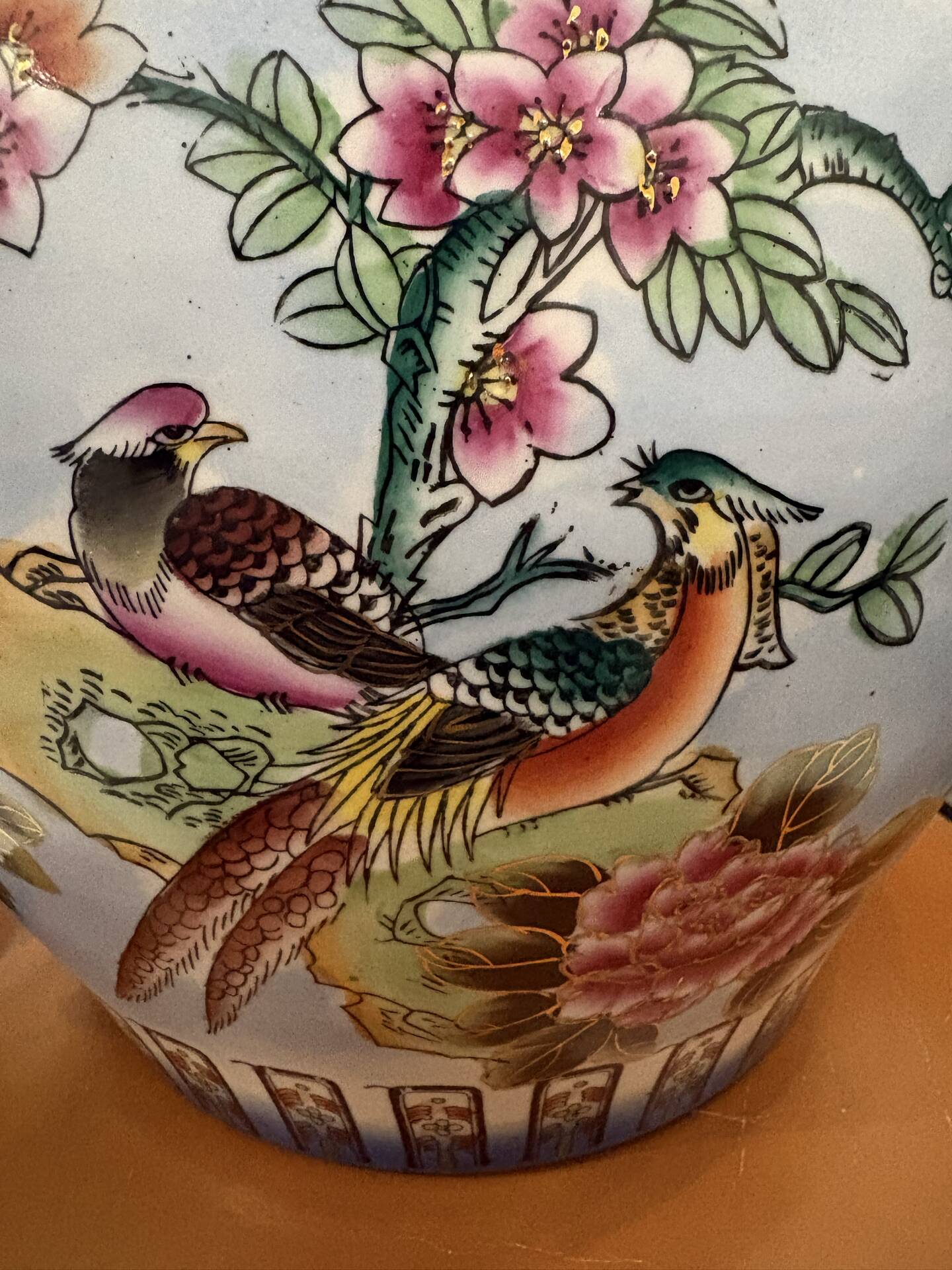 Antique porcelain vase with floral and bird decoration.