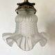 Antique brass wall light with glass shade.