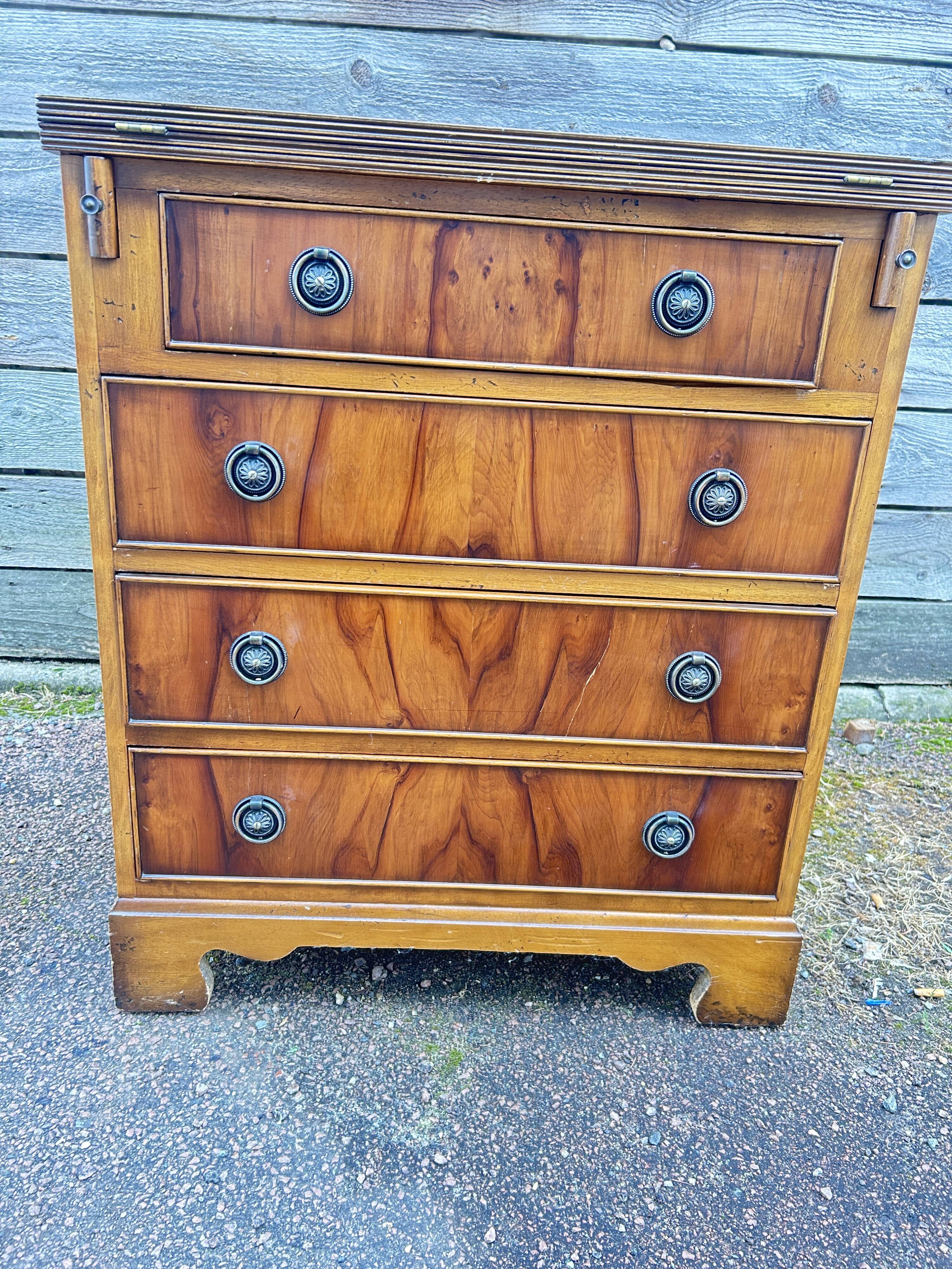 Small English chest of drawers with a folding top.