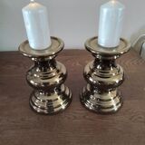 Two bronze-colored candlesticks