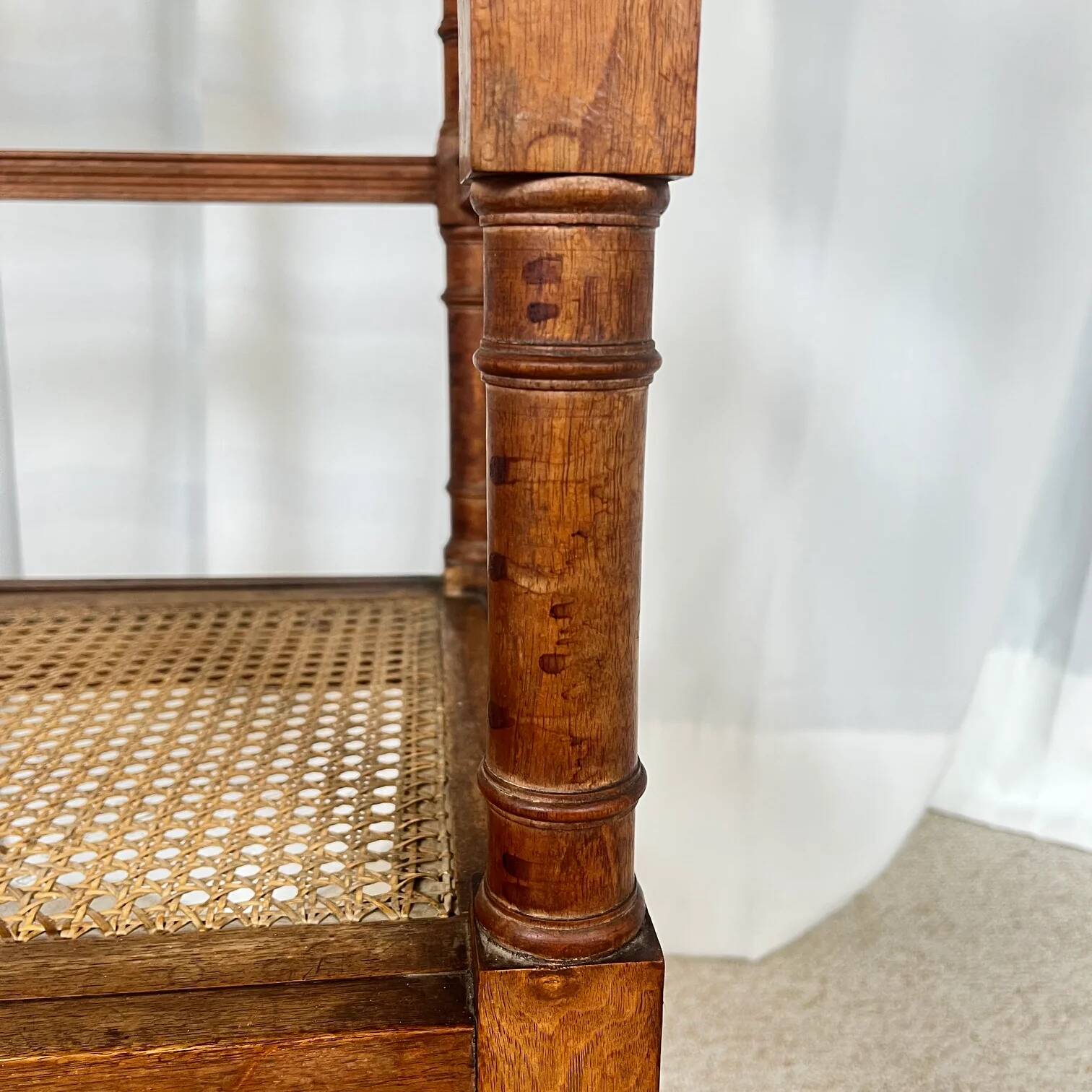 Antique banquette in Louis XIII style, turned wood with caning, late 19th to early 20th century.