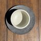 White Indonesian ceramic cup and gray saucer
