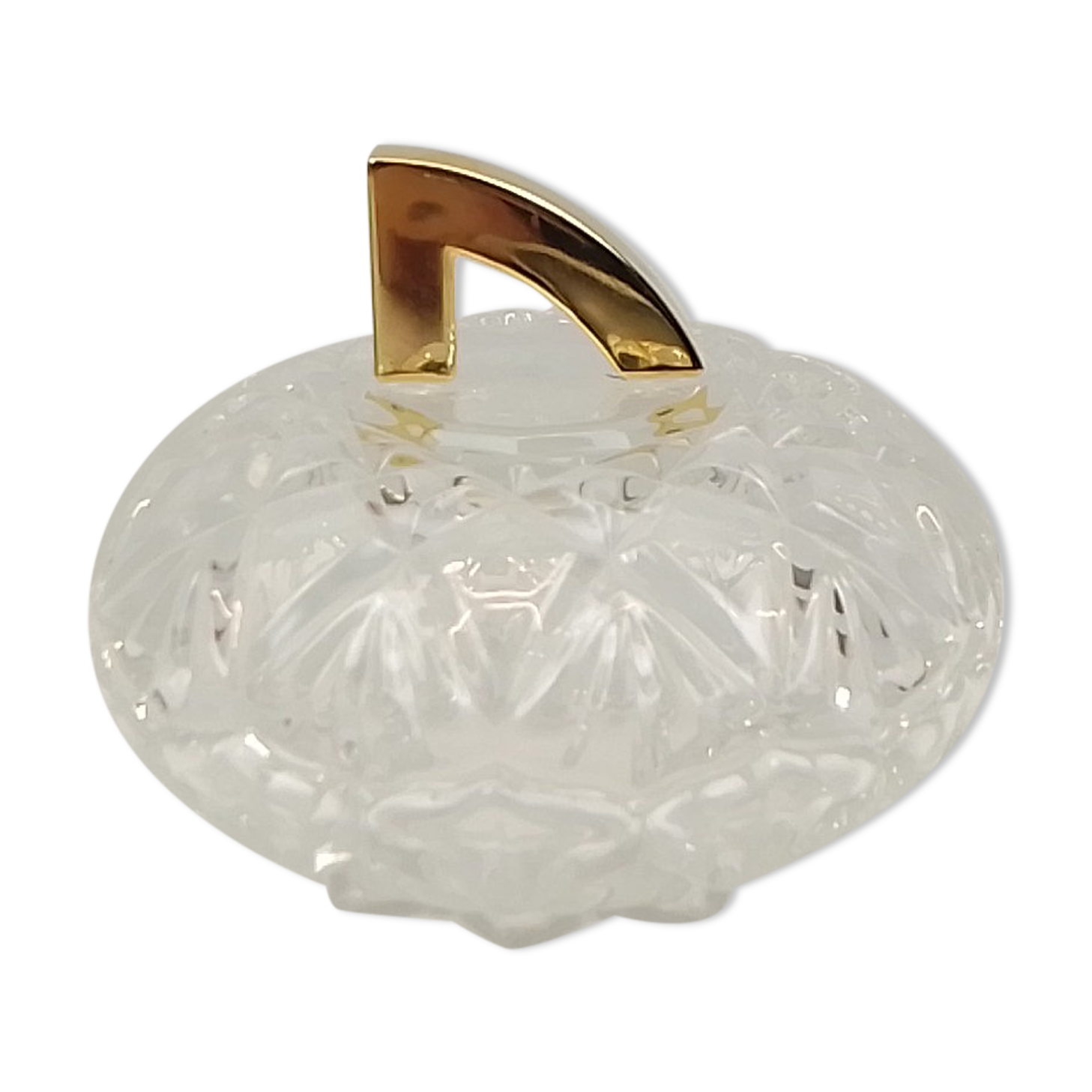 Round crystal box and a golden metal handle