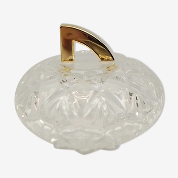 Round crystal box and a golden metal handle