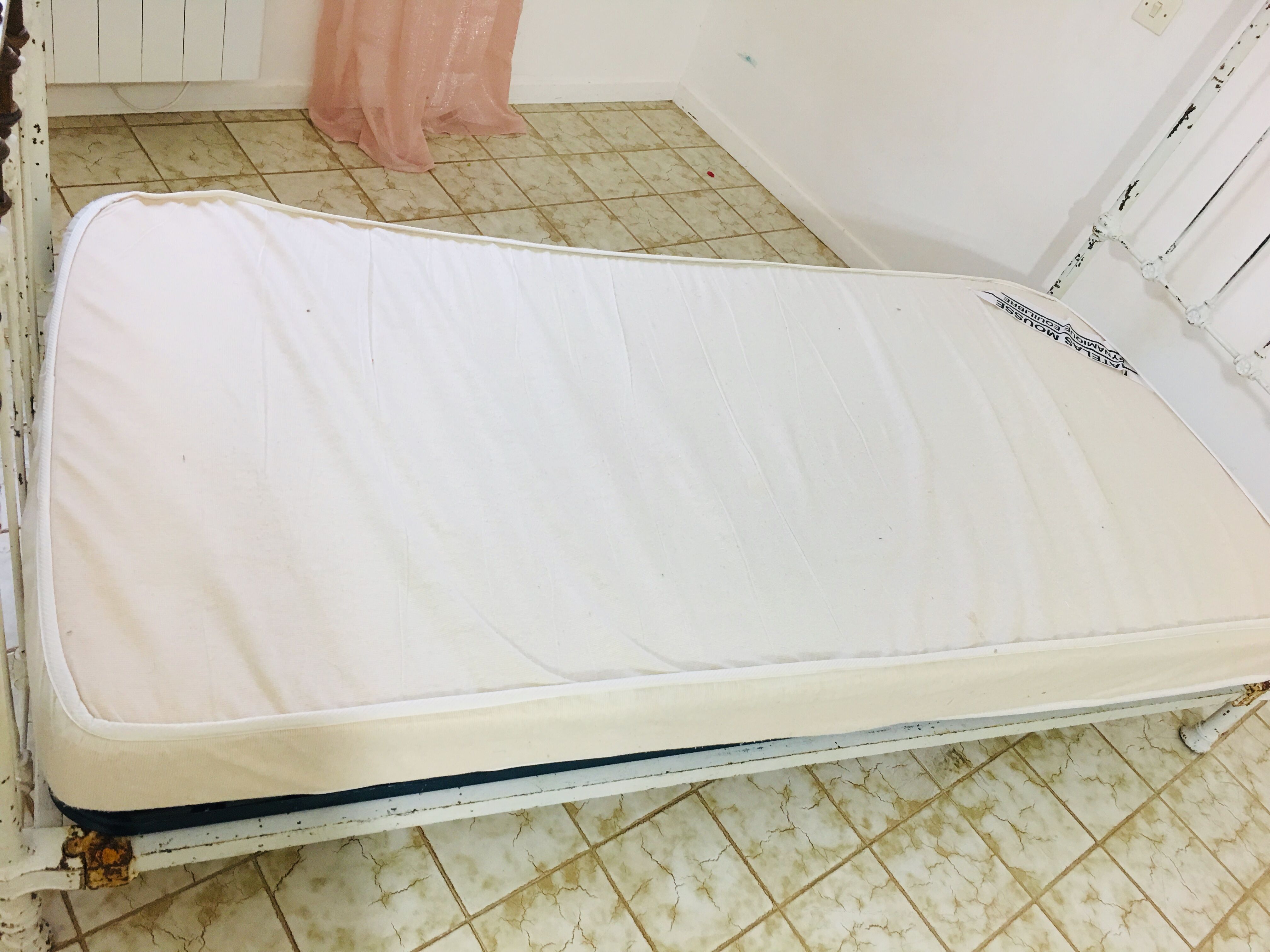 Old white metal and brass bed