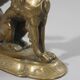 Handheld candlestick in bronze featuring a griffin, 19th-century Empire style.