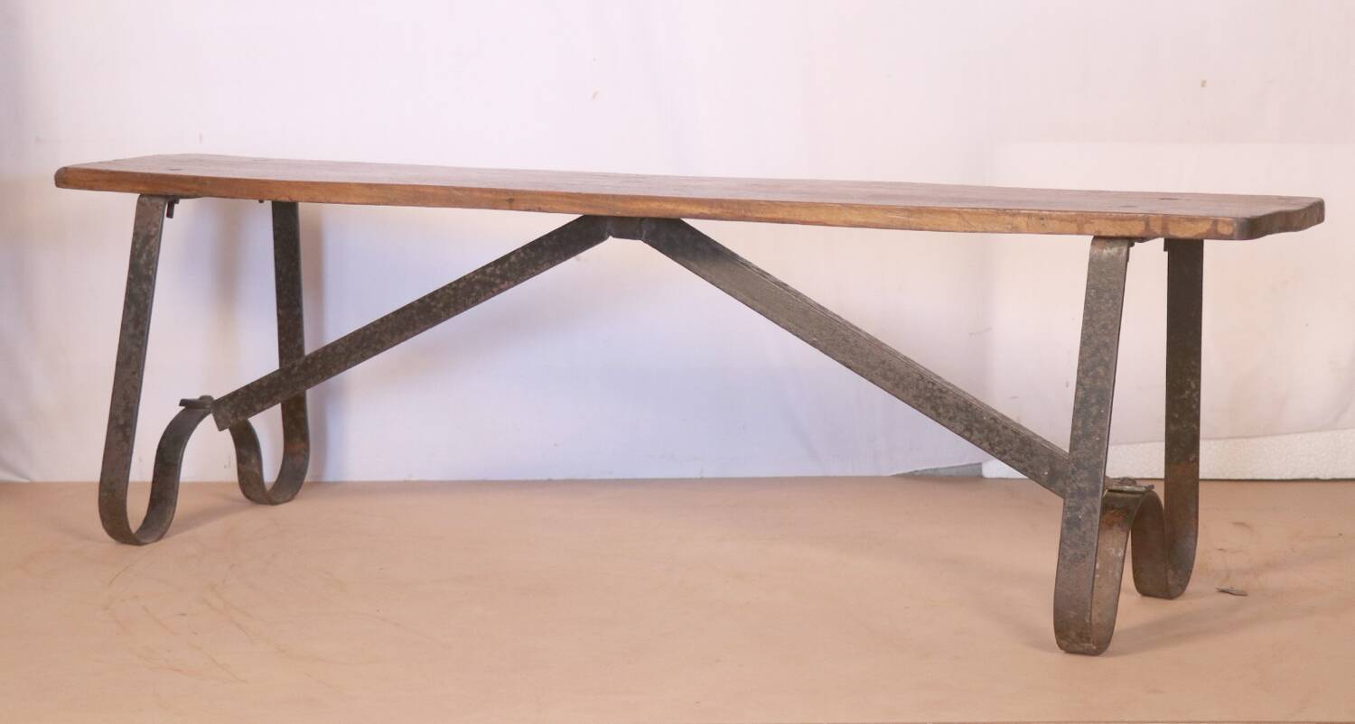 Old bench in Burmese teak with a wrought iron base.