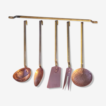 Set of copper and brass kitchen utensils with stand