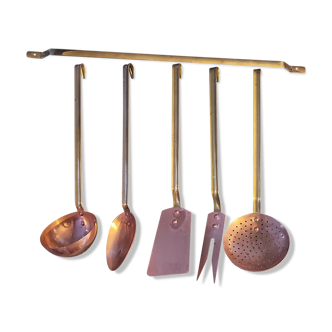 Set of copper and brass kitchen utensils with stand