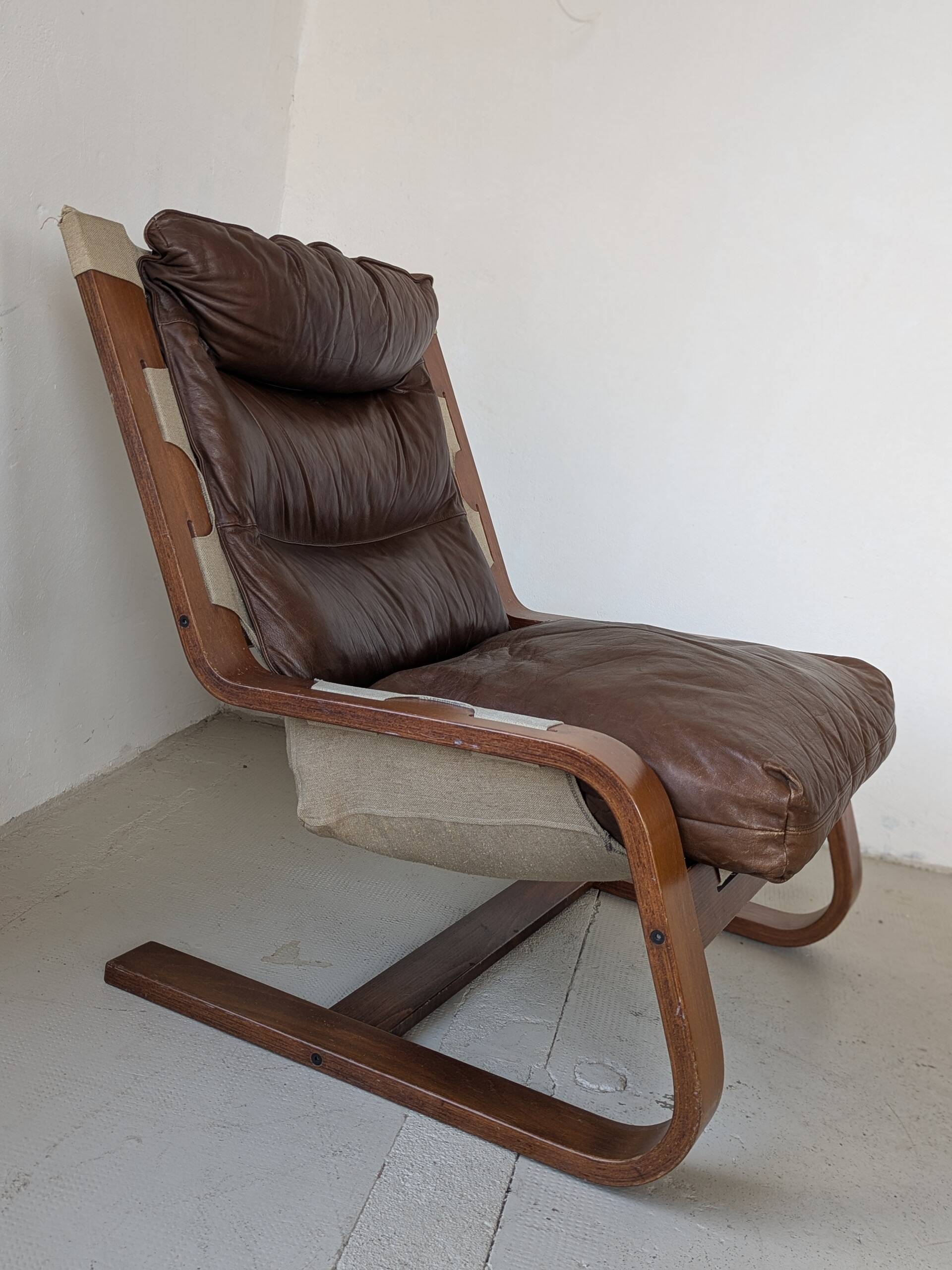 Leather and wood armchair, brutalist style.