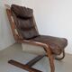 Leather and wood armchair, brutalist style.