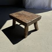 Small stool, rectangular solid teak side table with curved legs.