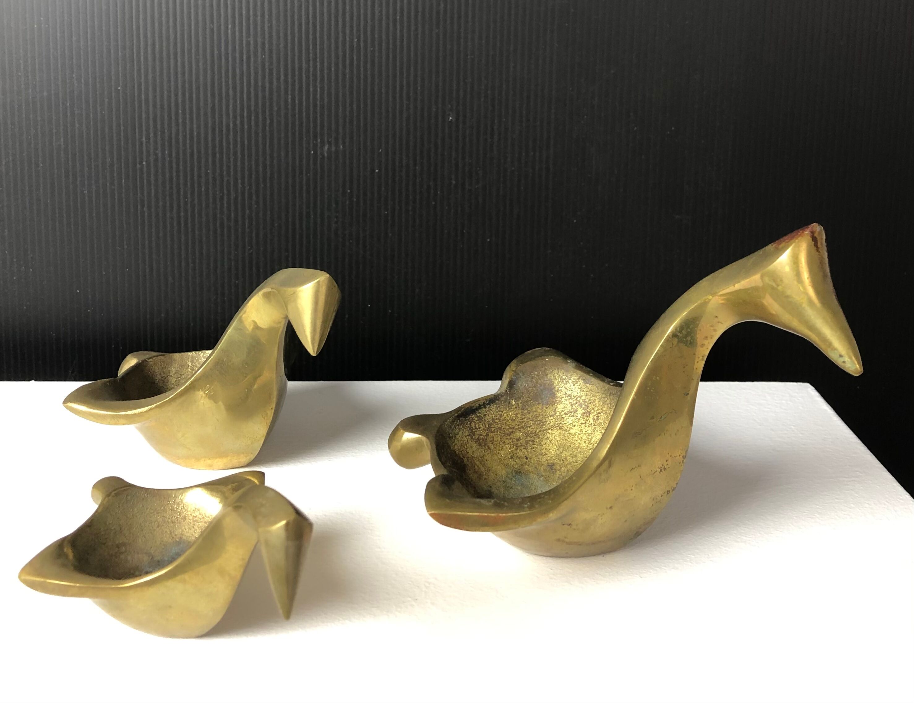 Suite of bronze "swan" ashtrays