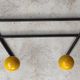 Two vintage metal and wood ball coat racks