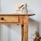 Small old farmhouse table in raw wood.
